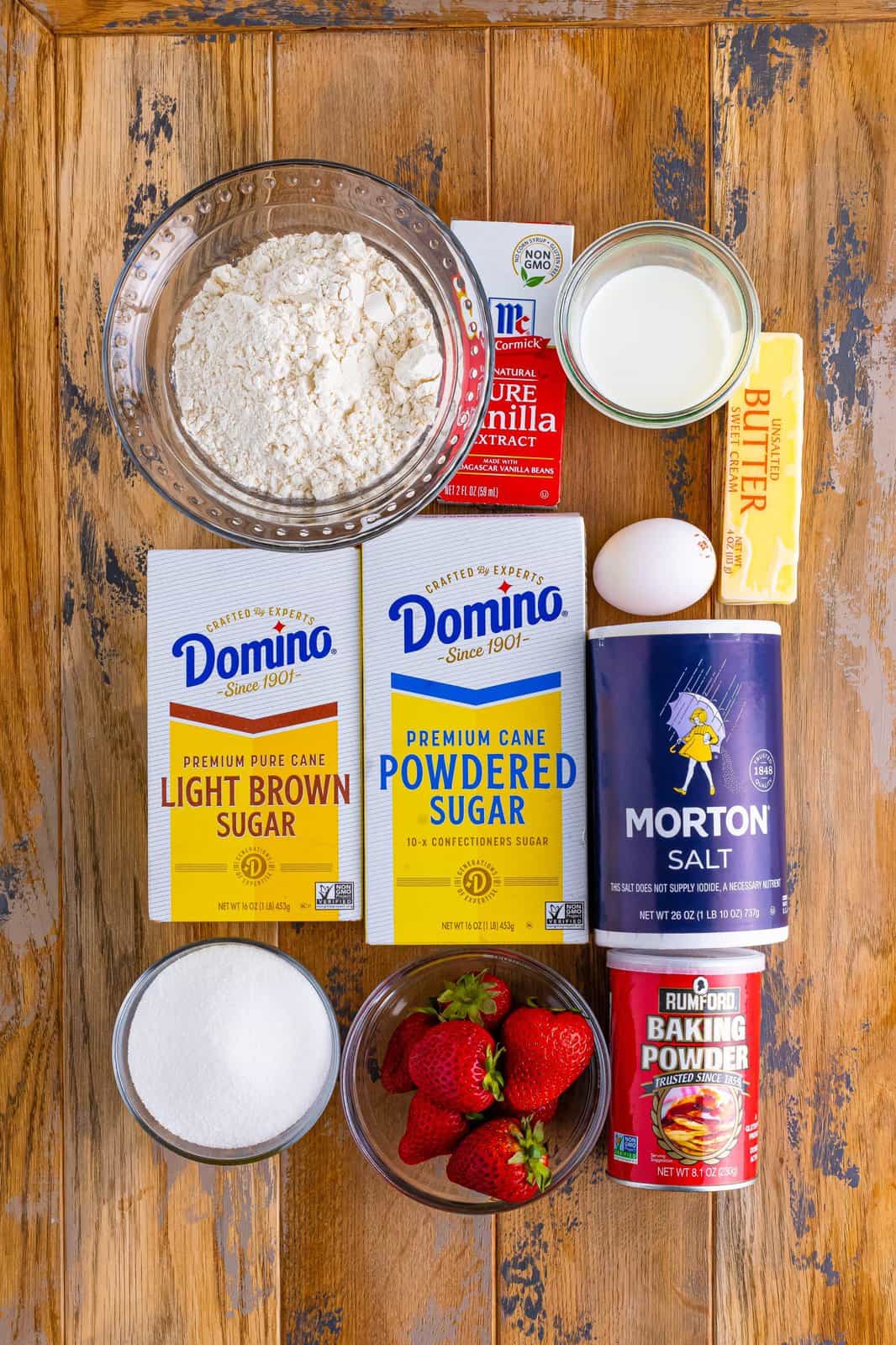 Flour, butter, brown sugar, strawberries, baking powder, salt, sugar, egg, vanilla extract, milk, and powdered sugar.