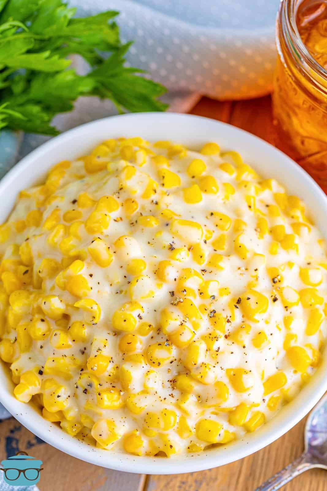 A white serving bowl of Creamed Corn.