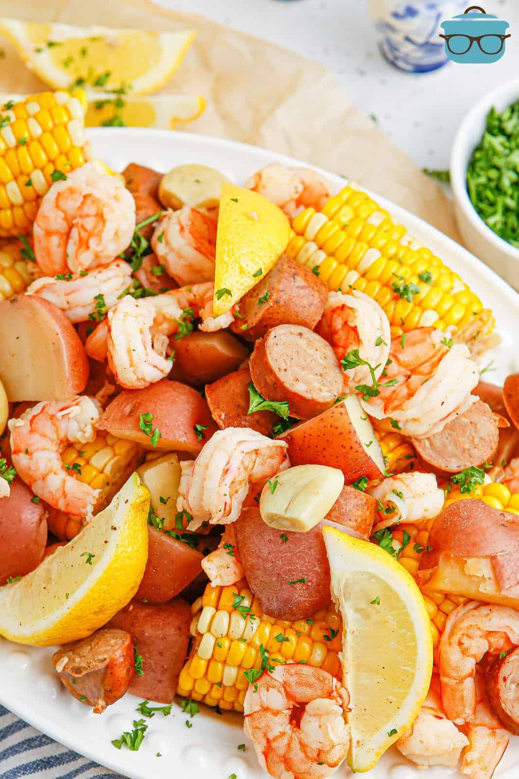 Looking closely at a Shrimp boil dinner on a platter.