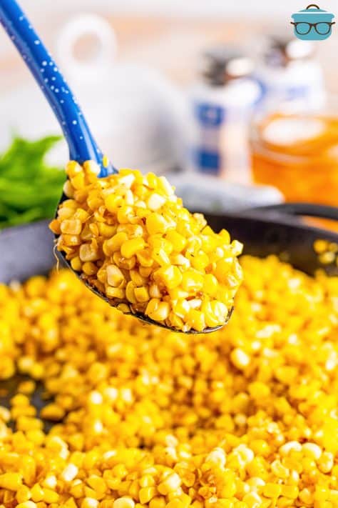 A serving spoon with a pile of Fried Corn above the rest.