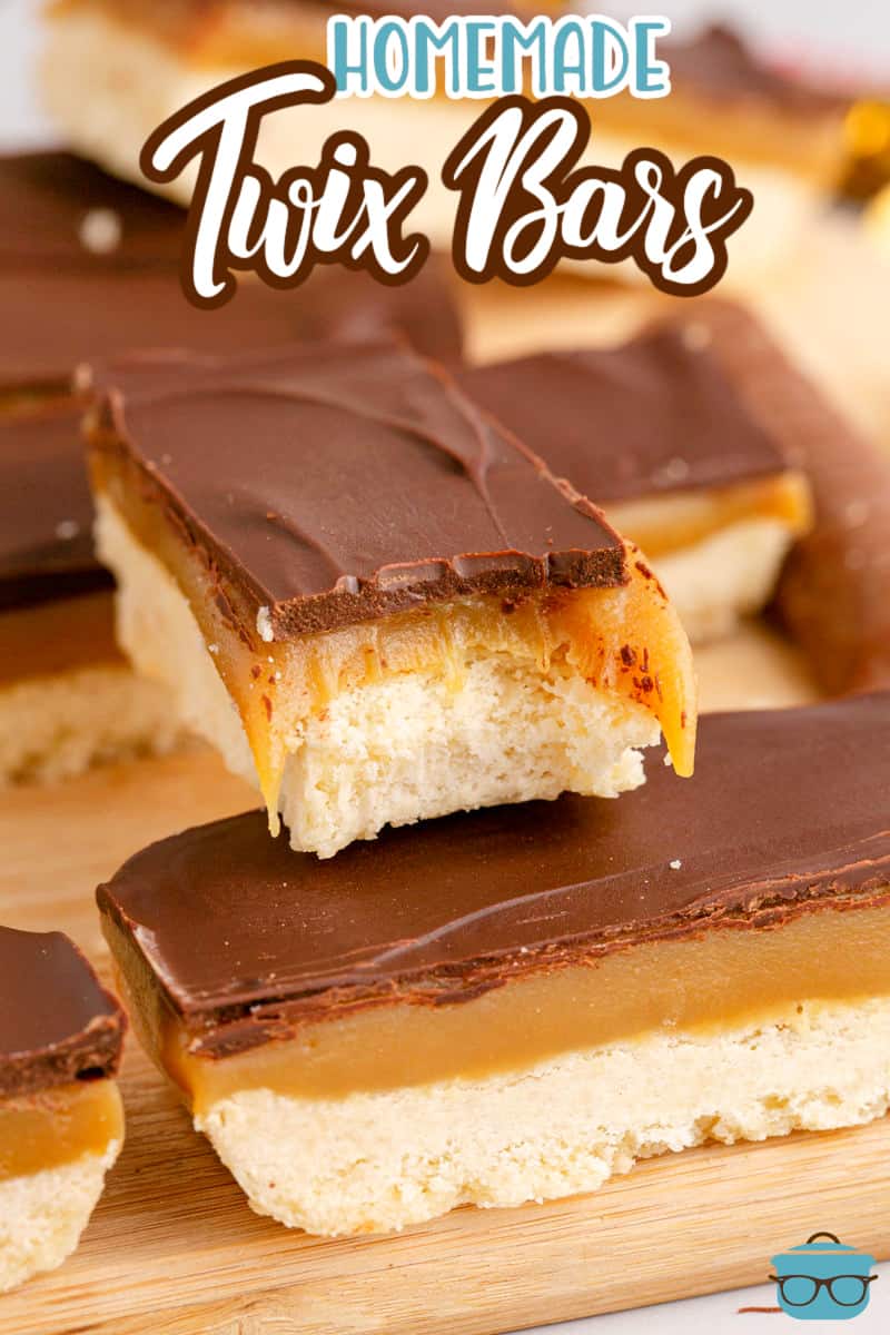 A homemade Twix Bar with a bite taken out on top of a few others.