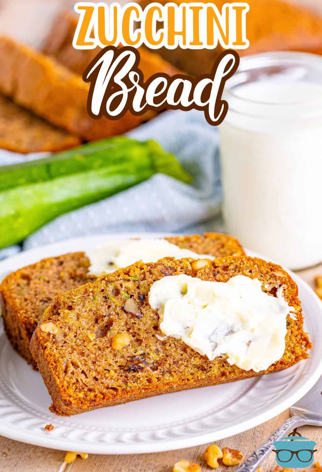 Two slices of Zucchini Bread with a sweet spread on top on a plate.