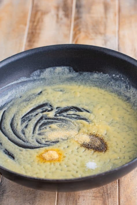 A saucepan with melted butter and spices.
