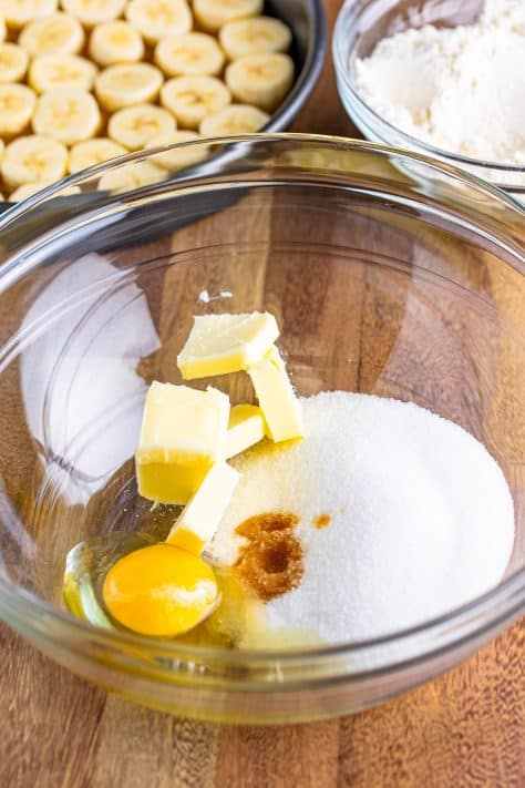 A mixing bowl with unsalted butter, granulated sugar, egg and vanilla extract.