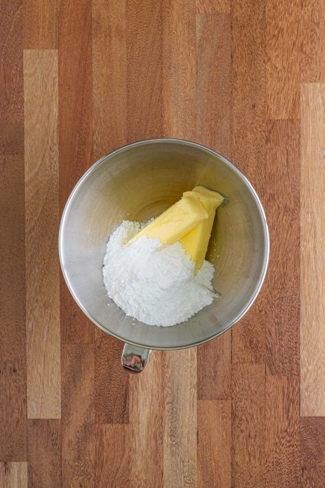 butter and powdered sugar in a mixing bowl.