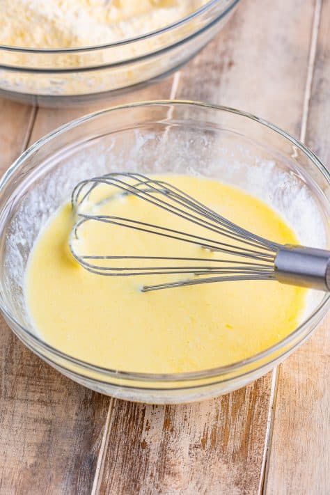 A mixing bowl with buttermilk, melted butter, and eggs whisked together.