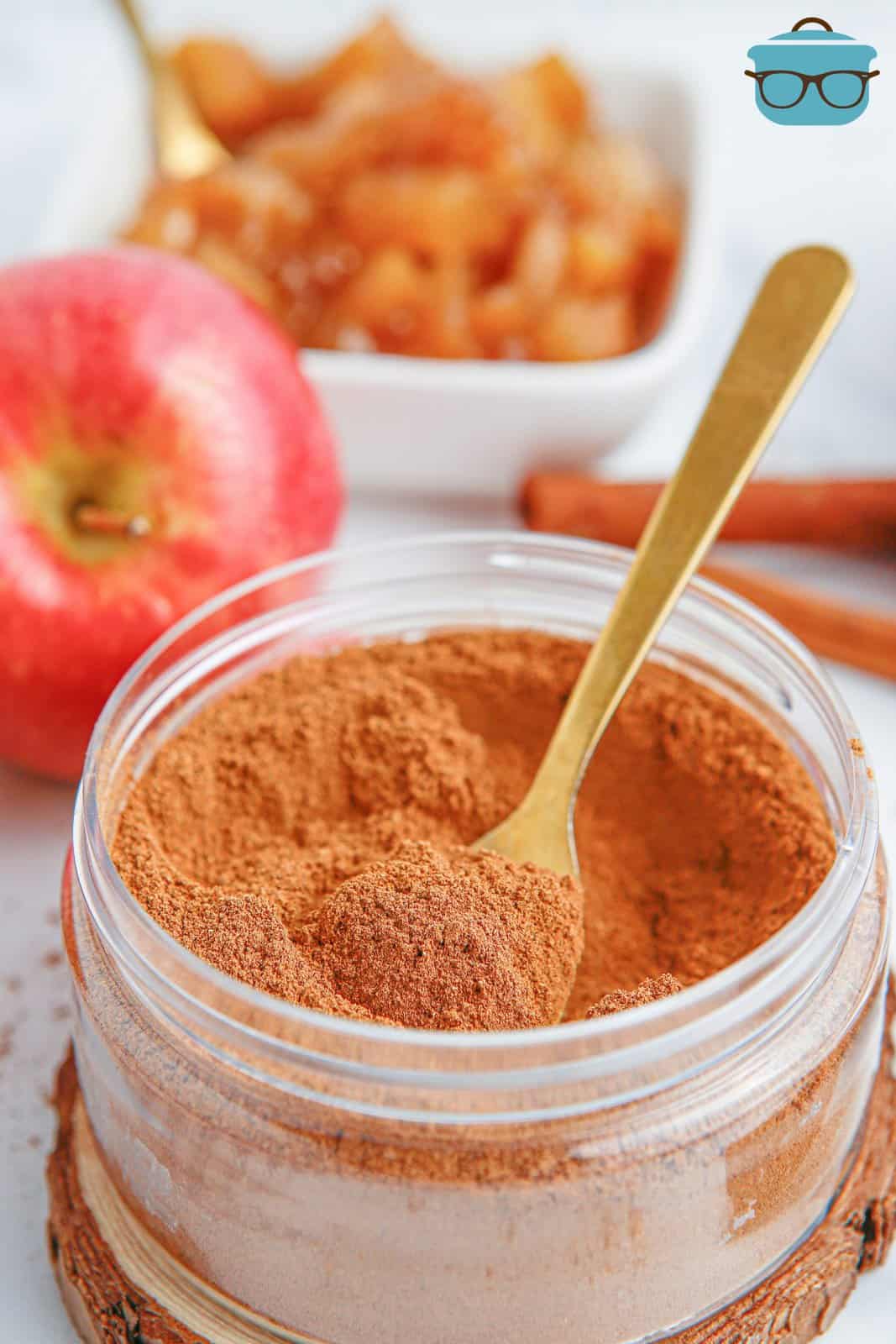 A spoon in a container of homemade Apple Pie Spice.