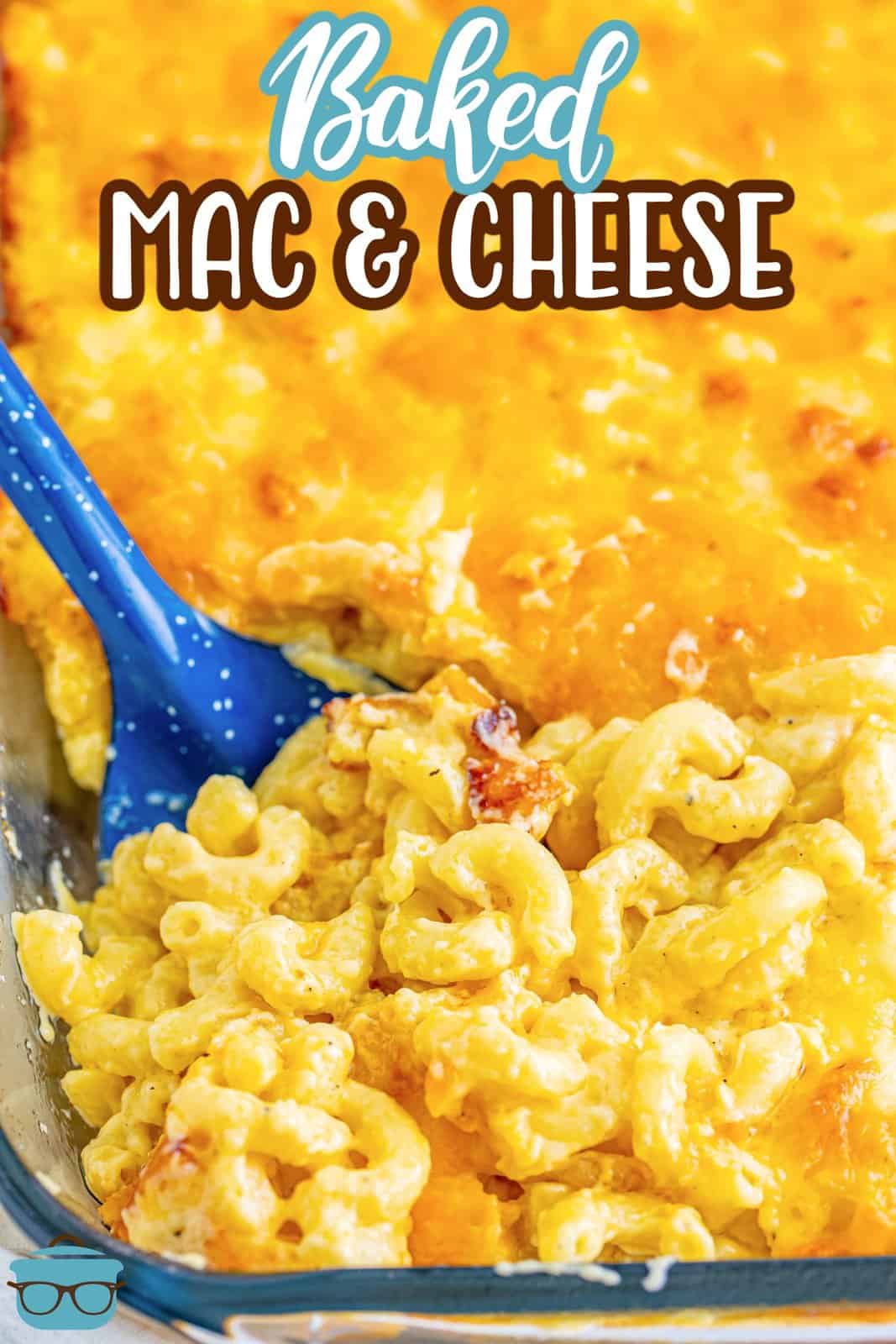 A baking dish with baked mac and cheese and a blue spoon dipping into it.