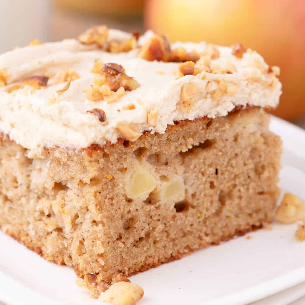 A close up look at a slice of Apple Spice Cake with homemade frosting.