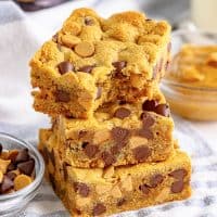 A stack of three peanut butter chocolate chip cookie bars.