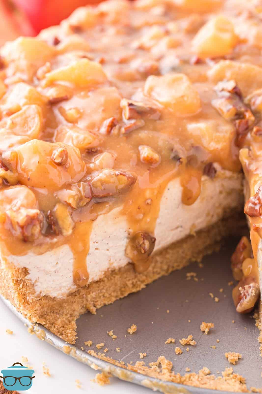 A No Bake Caramel Apple Cheesecake with a slice taken out.