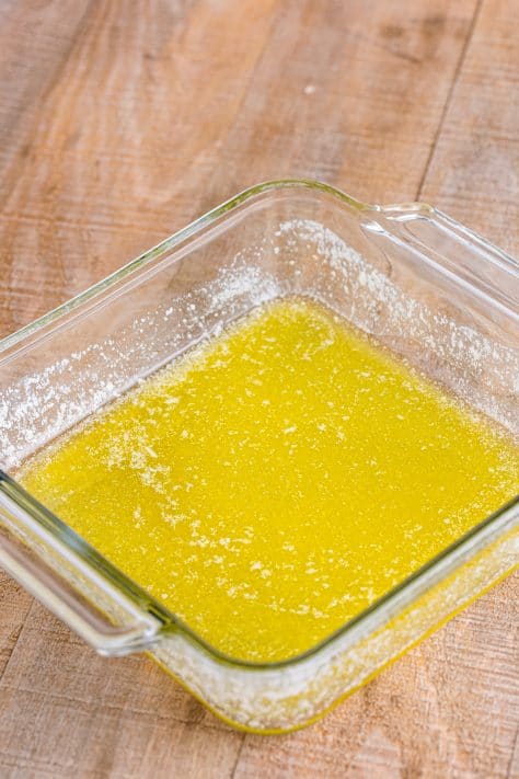 Melted butter in a baking dish.