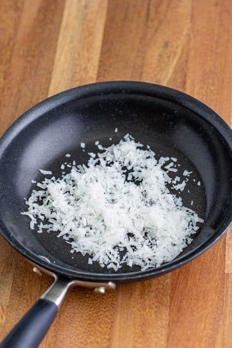 A skillet with coconut flakes.