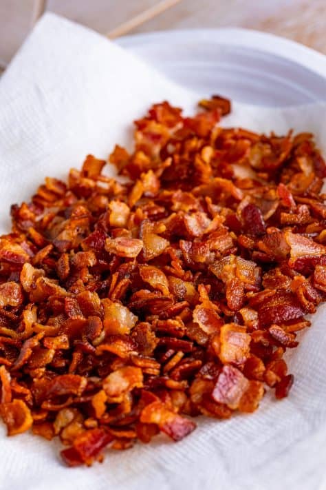 cooked bacon pieces on a paper towel.