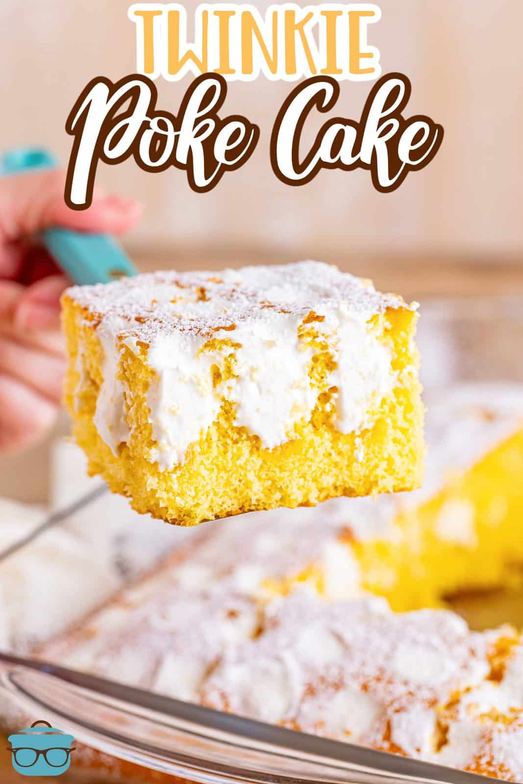 A slice of Twinkie Poke Cake held above the baking dish.