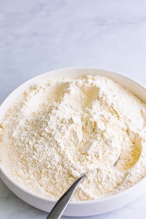 A bowl of all-purpose flour, cream of tartar, baking soda, and salt.