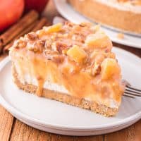 A slice of no bake caramel apple cheesecake on a plate.