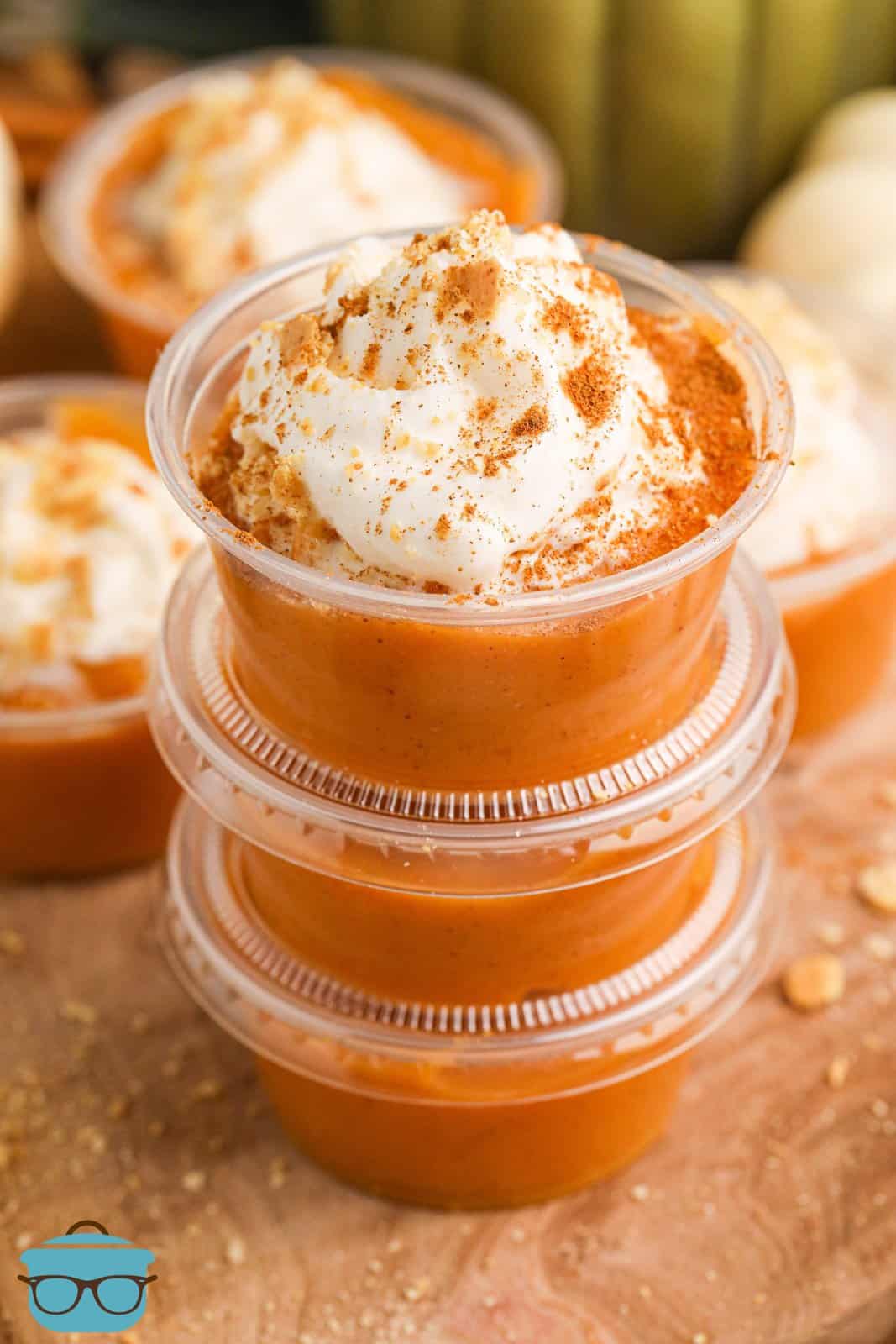 A stack of Pumpkin Pie Pudding Shots with the top one open.