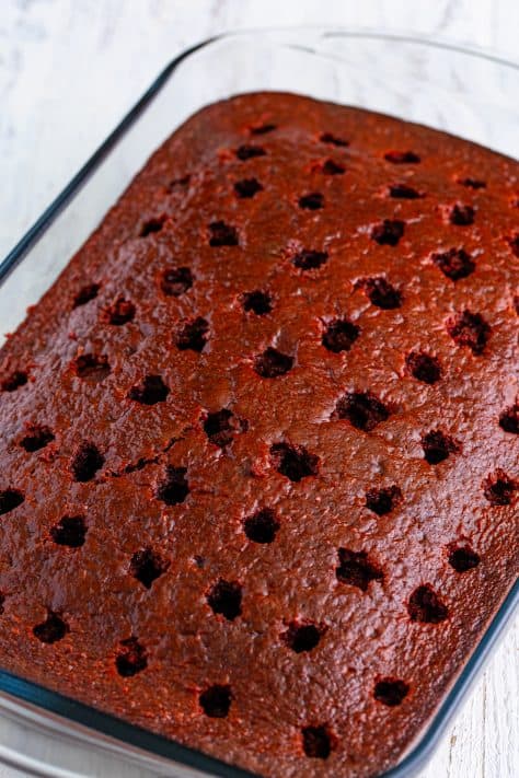 A cake with holes poked in it with jello poured in.
