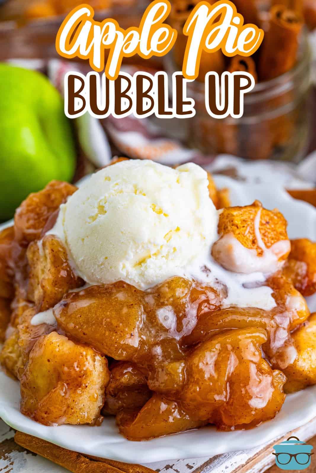 A scoop of ice cream on top of a dessert dish of Apple Pie Bubble Up.