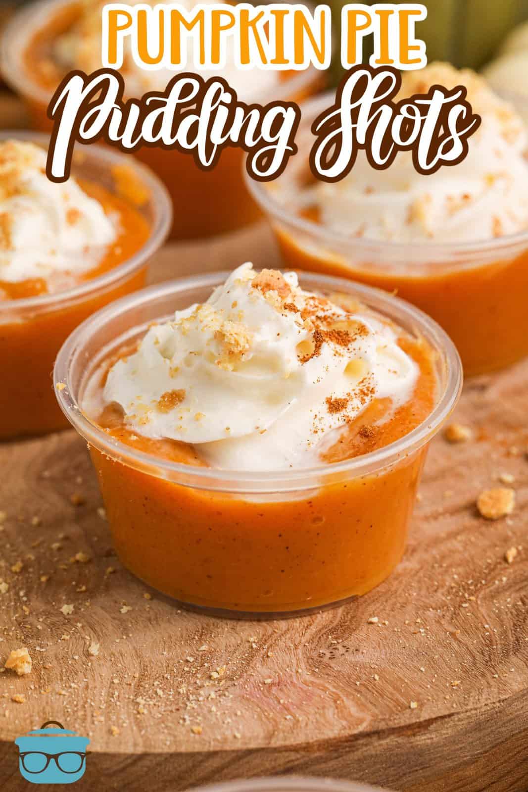 A few homemade Pumpkin Pie Pudding Shots with whipped cream on top.