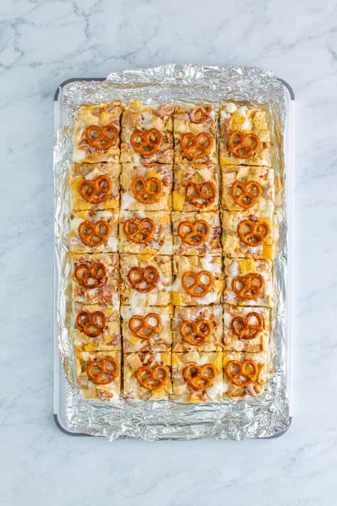 Sliced Chex Mix Marshmallow Treats on a baking tray.