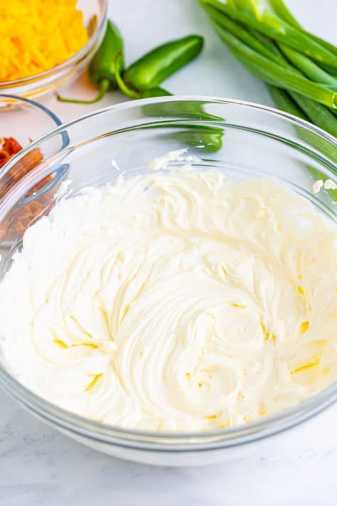 Cream cheese and sour cream in a mixing bowl.