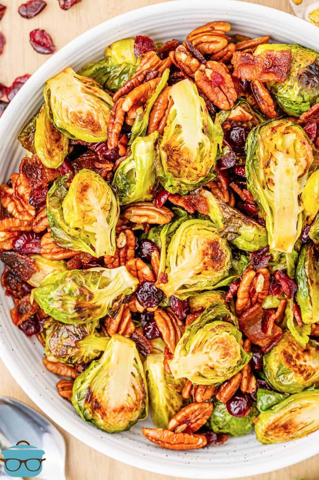 A white serving bowl of Holiday Roasted Brussels Sprouts.