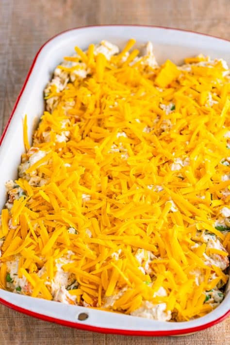 Shredded cheese on top of a chicken pot pie bubble up casserole dish.