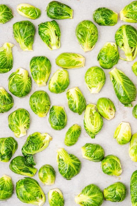 A baking sheet with brussels sprouts.