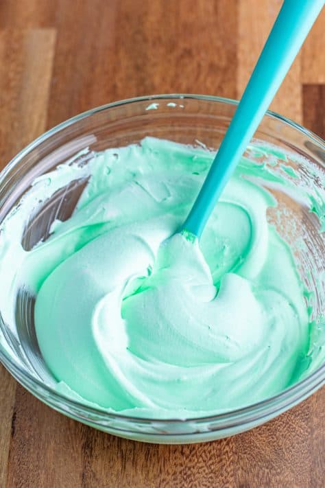 Whipped topping, mint extract, and green food coloring all mixed together.