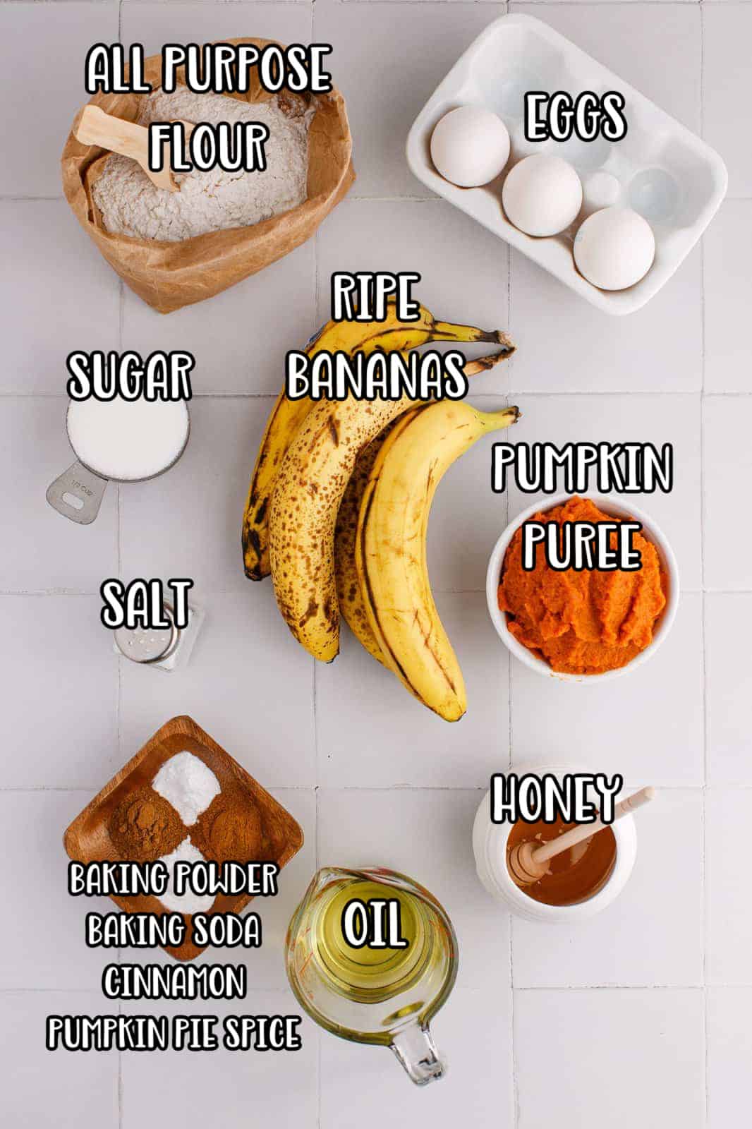 Bananas, pumpkin puree, flour, pumpkin spice, ground cinnamon, baking powder, baking soda, salt, eggs, honey, sugar, and vanilla extract.
