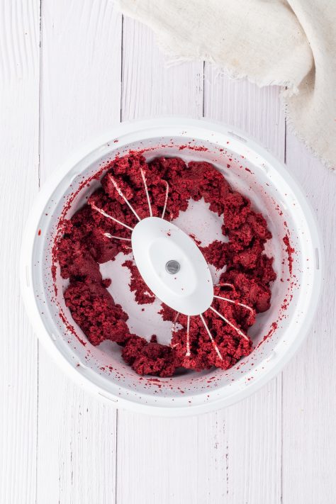 Red velvet cake crumbled up in a bowl.