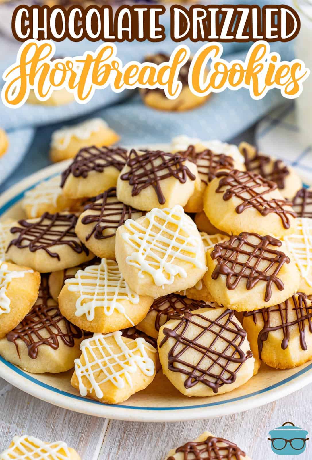 A plate of vanilla and chocolate drizzled shortbread cookies.