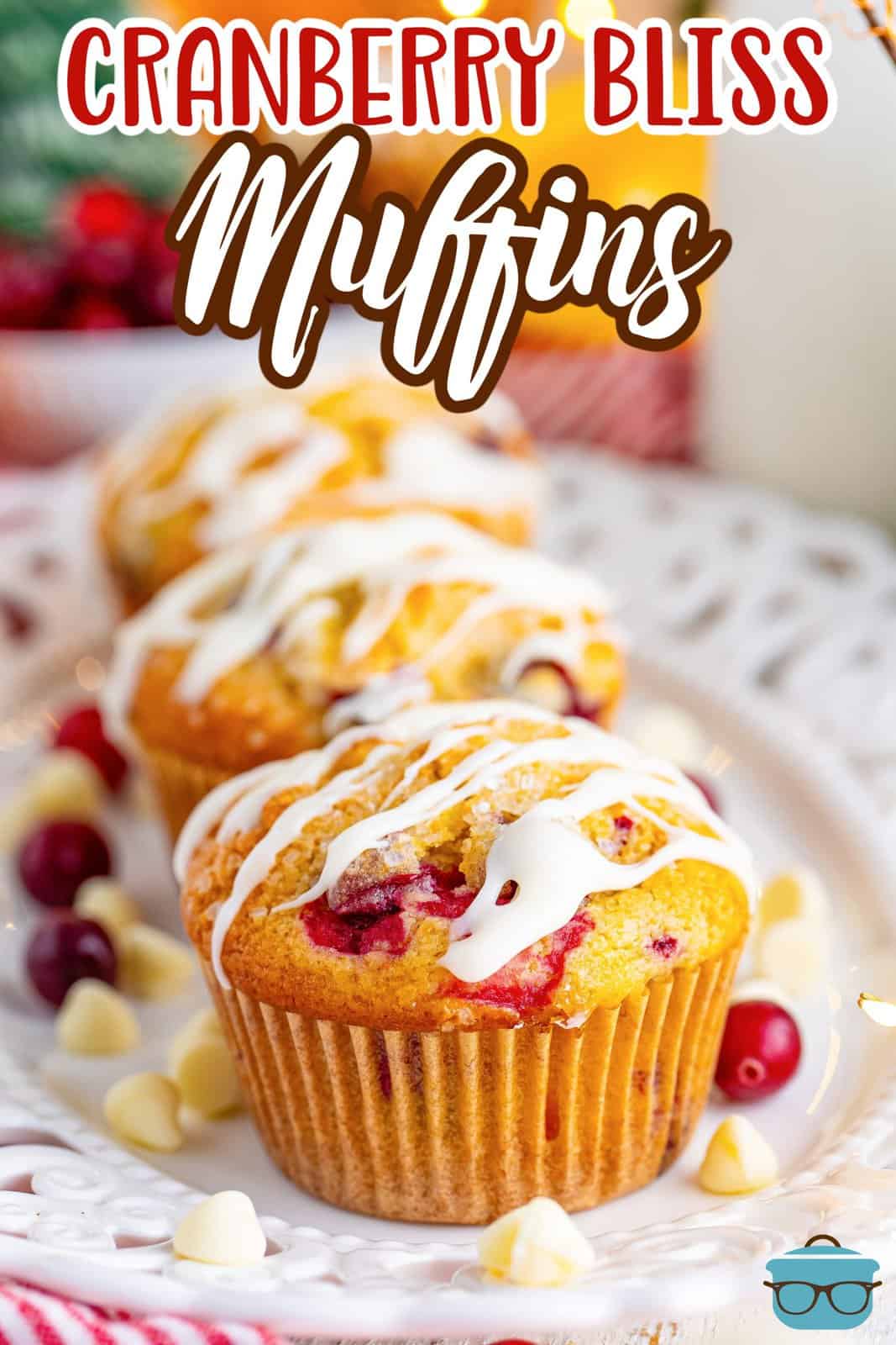 A line of a few homemade Cranberry Bliss Muffins on a plate.