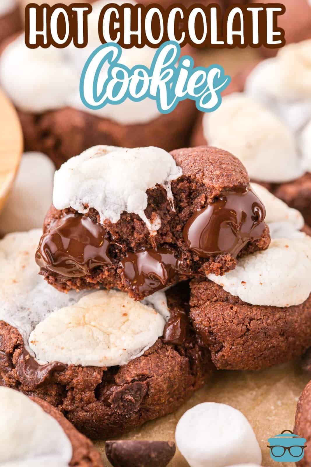 A broken Hot Chocolate Marshmallow Cookie on top of a few other cookies.