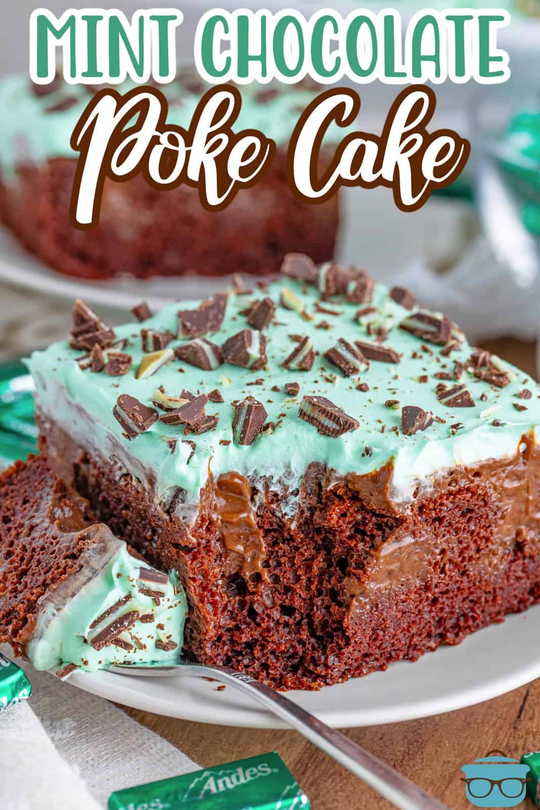 A slice of Mint Chocolate Poke Cake with a fork on a plate.