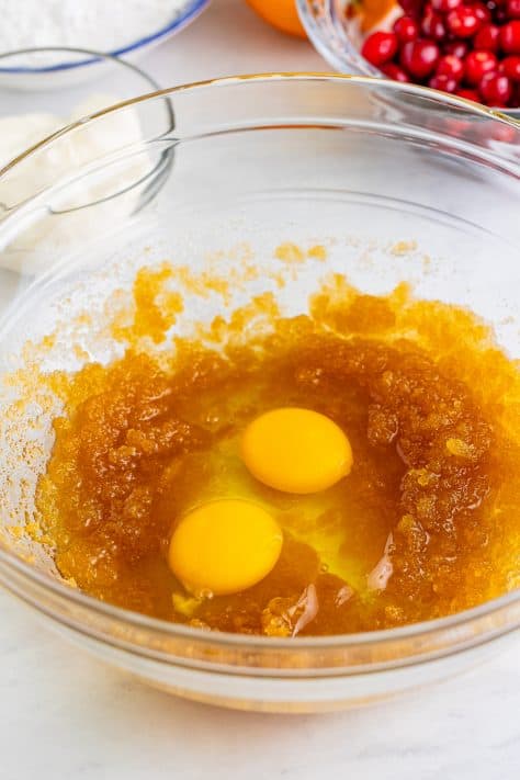 Eggs, oil, and brown sugar in a bowl.