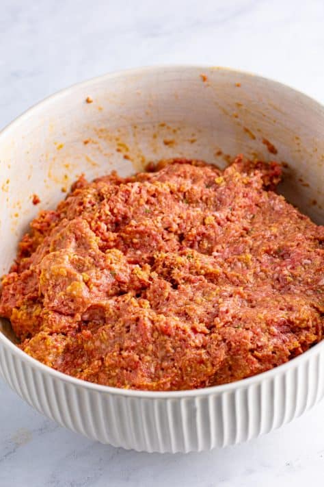 Meatloaf mixture in a mixing bowl.