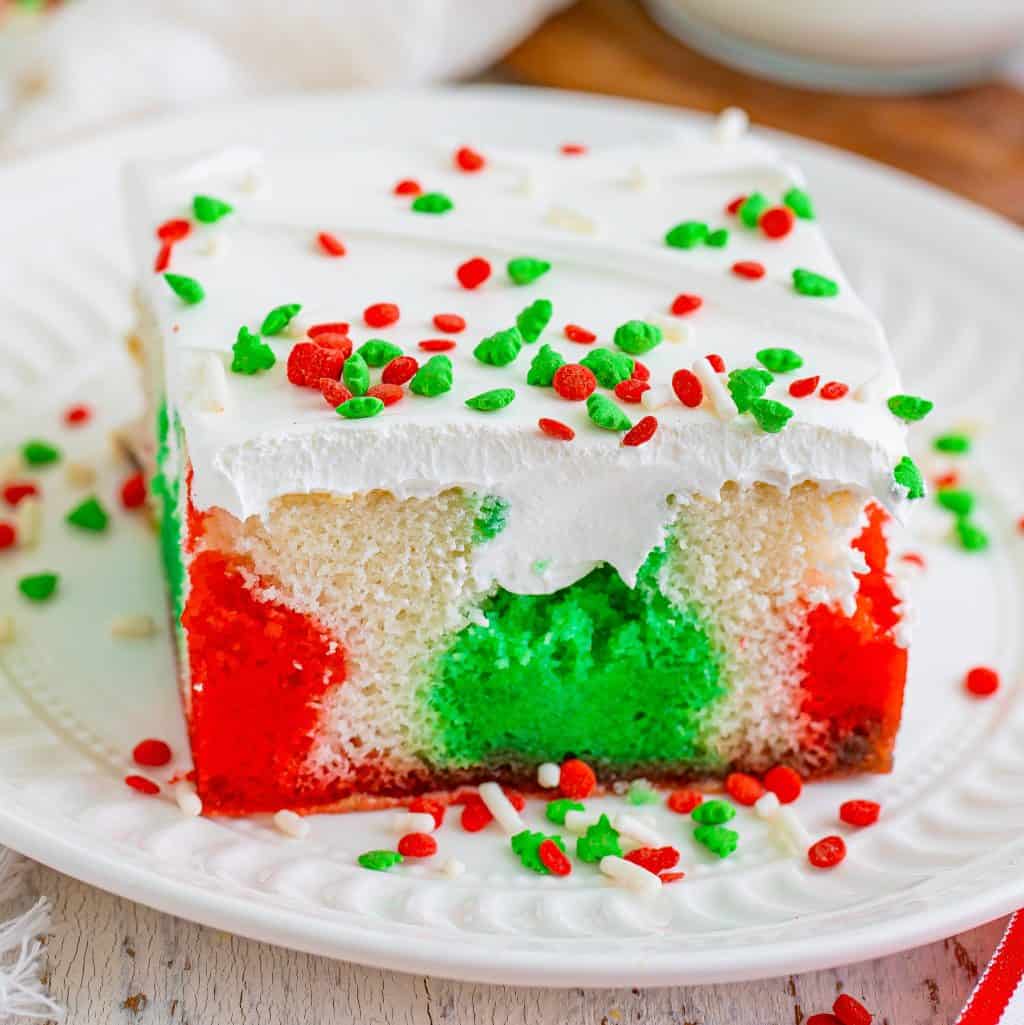 A slice of red, white, and green Poke Cake.