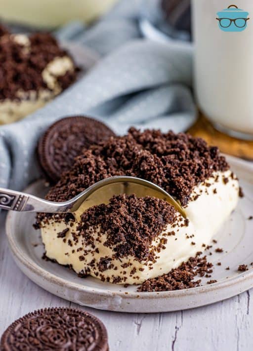 A spoon dipping into a slice of Oreo Dirt Cake.