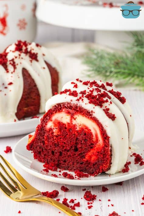 A serving plate with a piece of Red Velvet Cheesecake Bundt Cake.