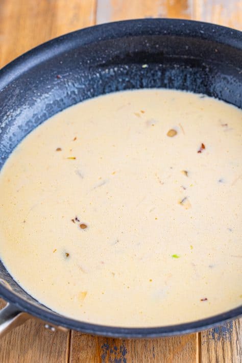 A creamy sauce in a skillet.