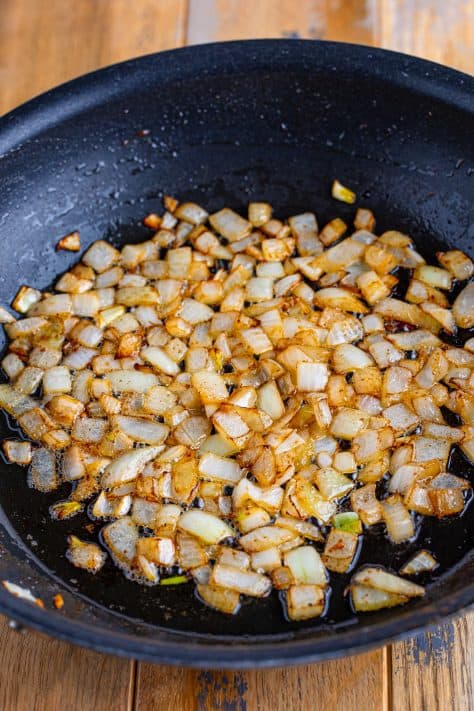 Cooked diced onion in a skillet.