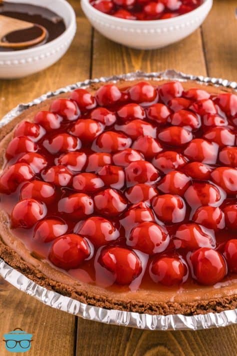 Cherry pie filling on top of chocolate cheesecake.
