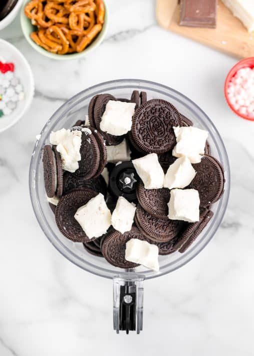 Oreos and cream cheese in a food processor.
