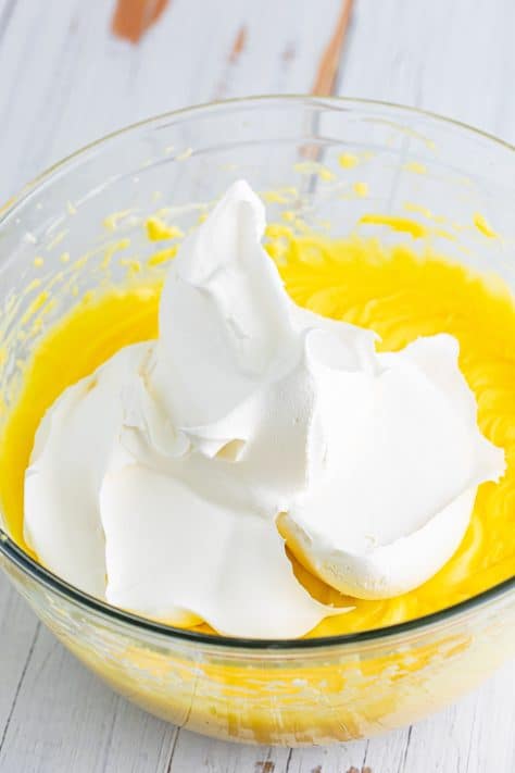 Whipped topping being added to a pudding cream filling mixture.