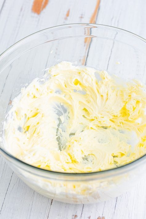 Cream cheese and butter being mixed together.