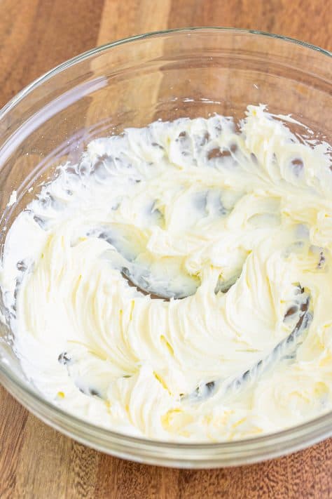 Cream cheese and powdered sugar creamed together in a mixing bowl.
