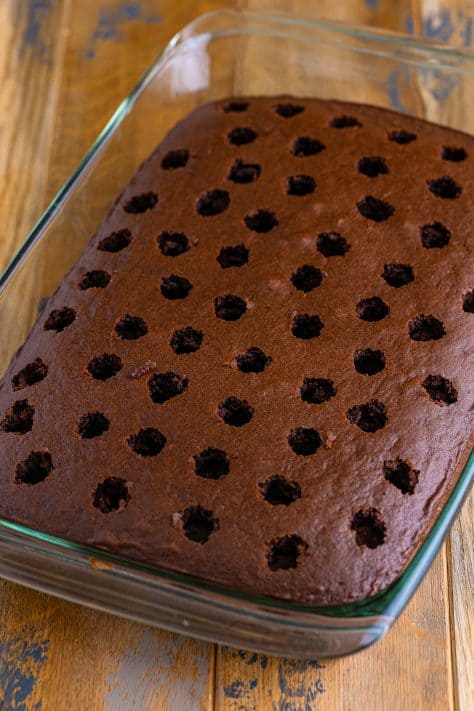A chocolate cake with holes poked in it.